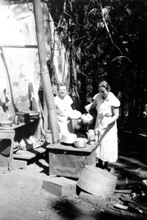Ruby Merrill & Mabel Estel cooking at Merrill's Sawmill, August 1935
