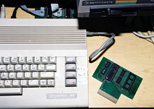 Another view of an unpopulated board next to the C64