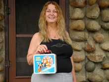 ...and holding her 2013 birthday gift, the same lunch box