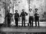 Charlie Walker with crew hewing beams for construction in YNP