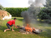 In a non-traditional approach, Jacob chops wood after it's on the fire